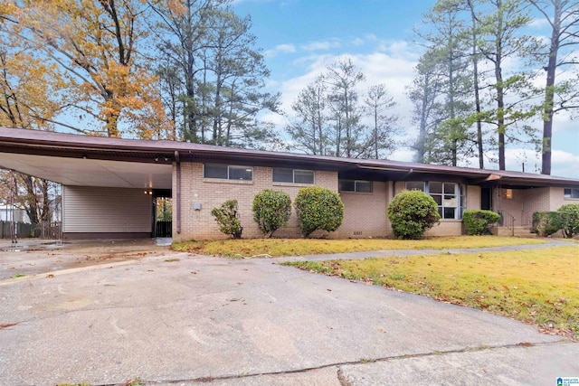 ranch-style home featuring a front yard and a carport