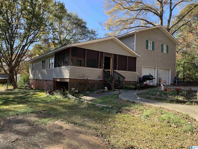 view of front facade with a garage and a sunroom