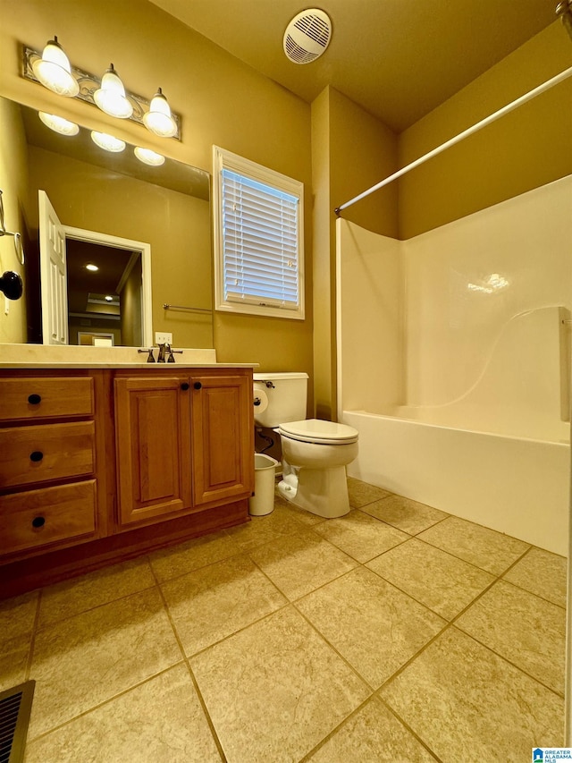 full bathroom with toilet, vanity, tile patterned floors, and washtub / shower combination