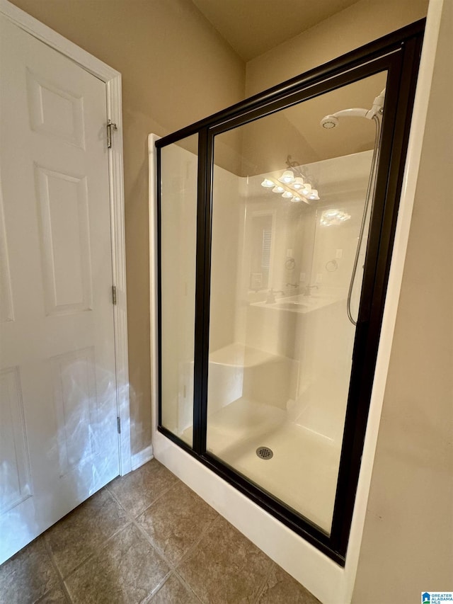 bathroom featuring tile patterned floors and a shower with door