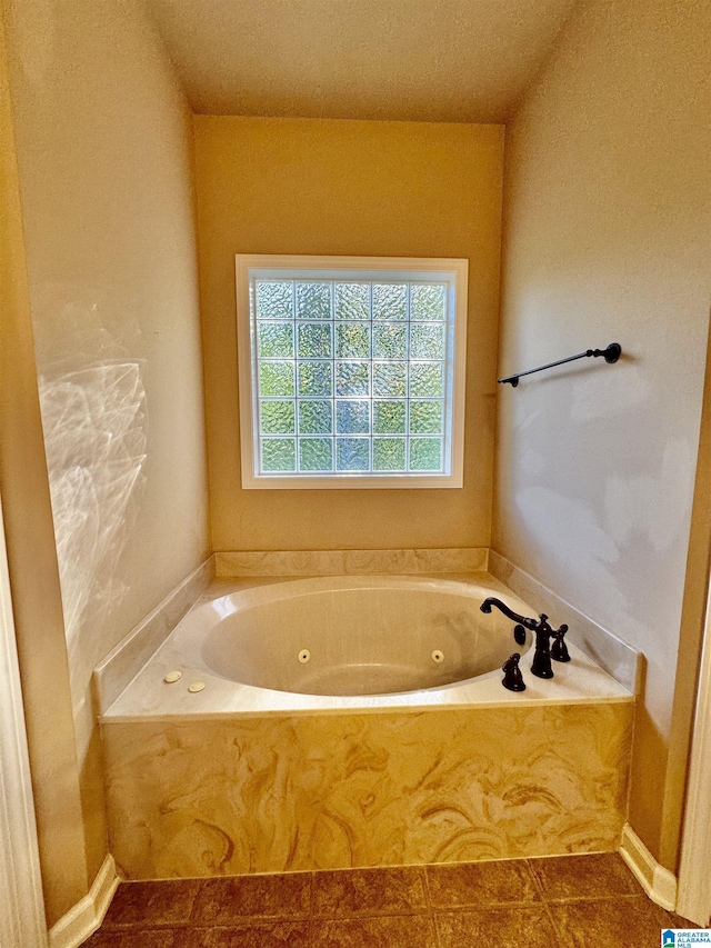 bathroom featuring tile patterned flooring and a washtub