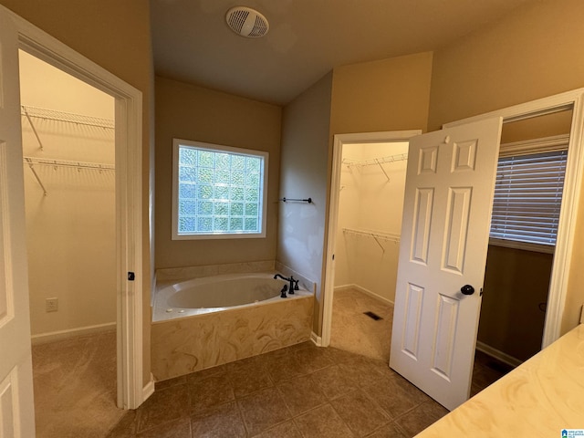 bathroom featuring a bathtub and tile patterned flooring