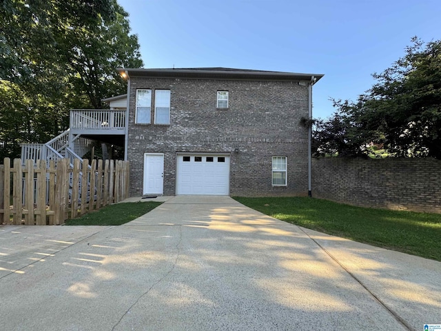 exterior space with a garage and a deck