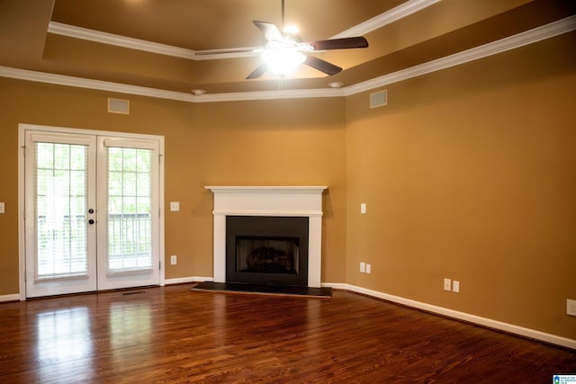 unfurnished living room featuring french doors, a raised ceiling, hardwood / wood-style flooring, ceiling fan, and ornamental molding