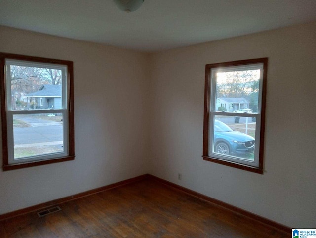 spare room with dark hardwood / wood-style floors