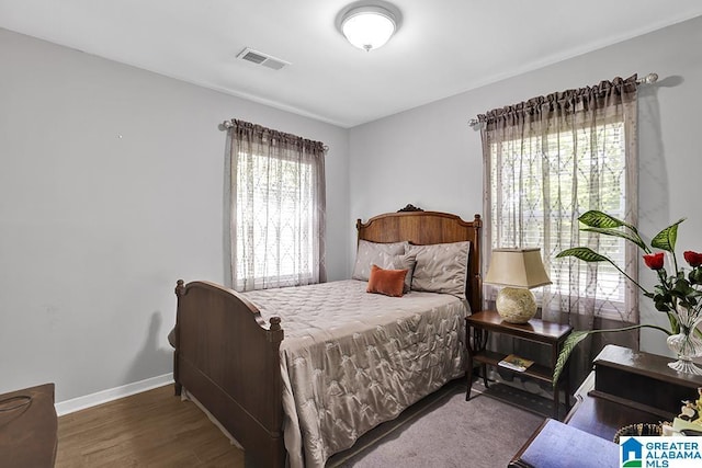 bedroom with dark hardwood / wood-style flooring