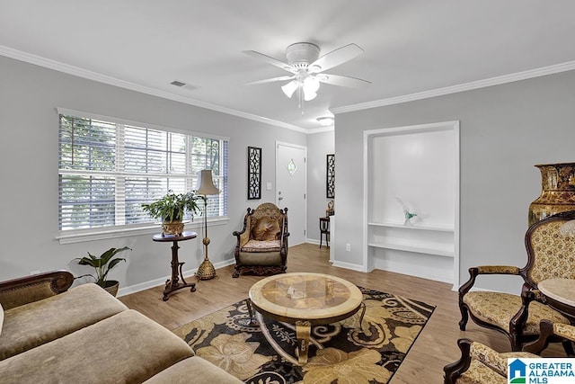 living room featuring ceiling fan, light hardwood / wood-style floors, and ornamental molding