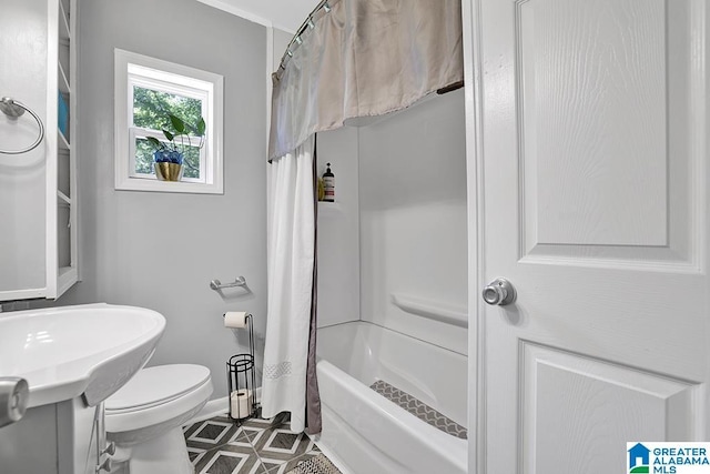 bathroom with shower / bath combo and toilet