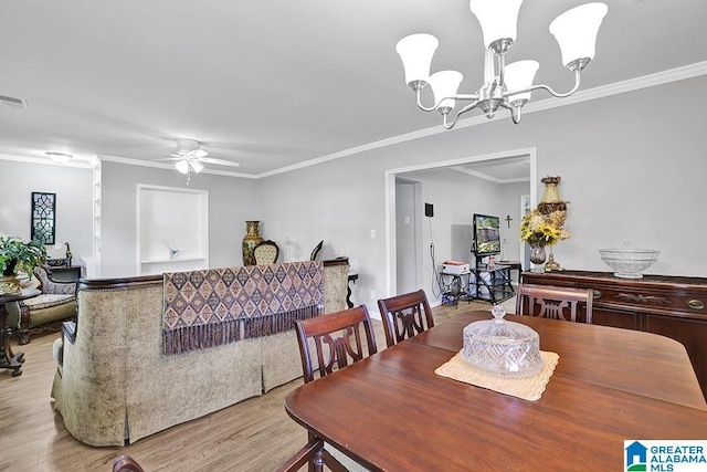 dining space with light hardwood / wood-style flooring, ceiling fan with notable chandelier, and ornamental molding