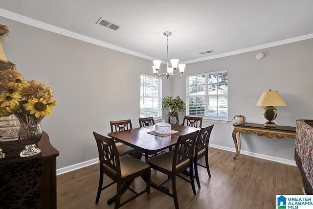 dining space featuring a chandelier, dark hardwood / wood-style floors, and crown molding