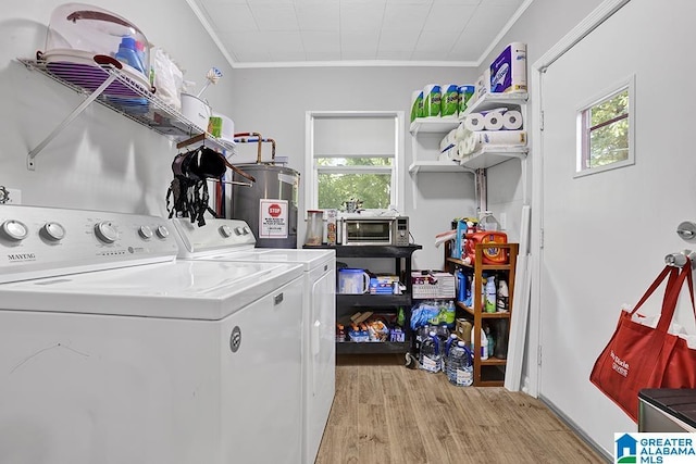 washroom featuring water heater, plenty of natural light, and crown molding