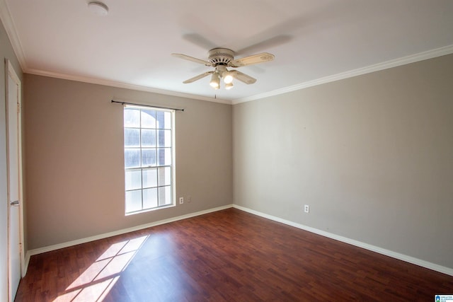 spare room with crown molding, ceiling fan, and dark wood-type flooring