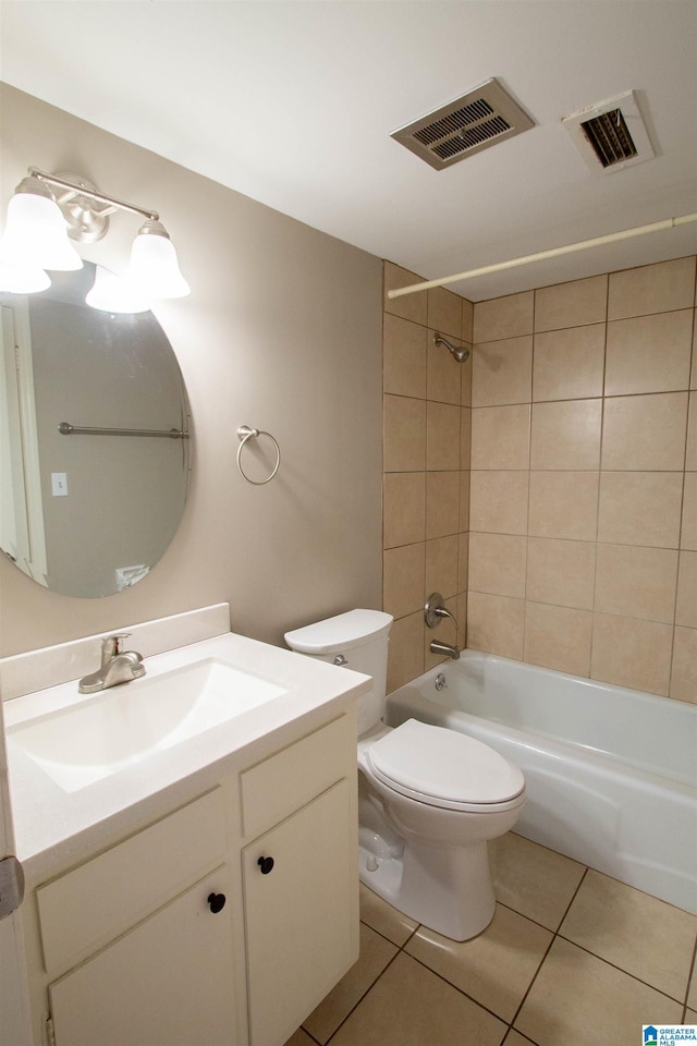 full bathroom featuring tile patterned floors, vanity, tiled shower / bath combo, and toilet