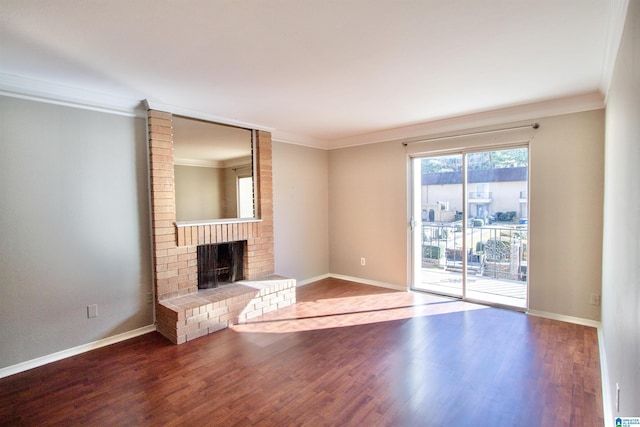 unfurnished living room featuring hardwood / wood-style flooring, ornamental molding, and a fireplace