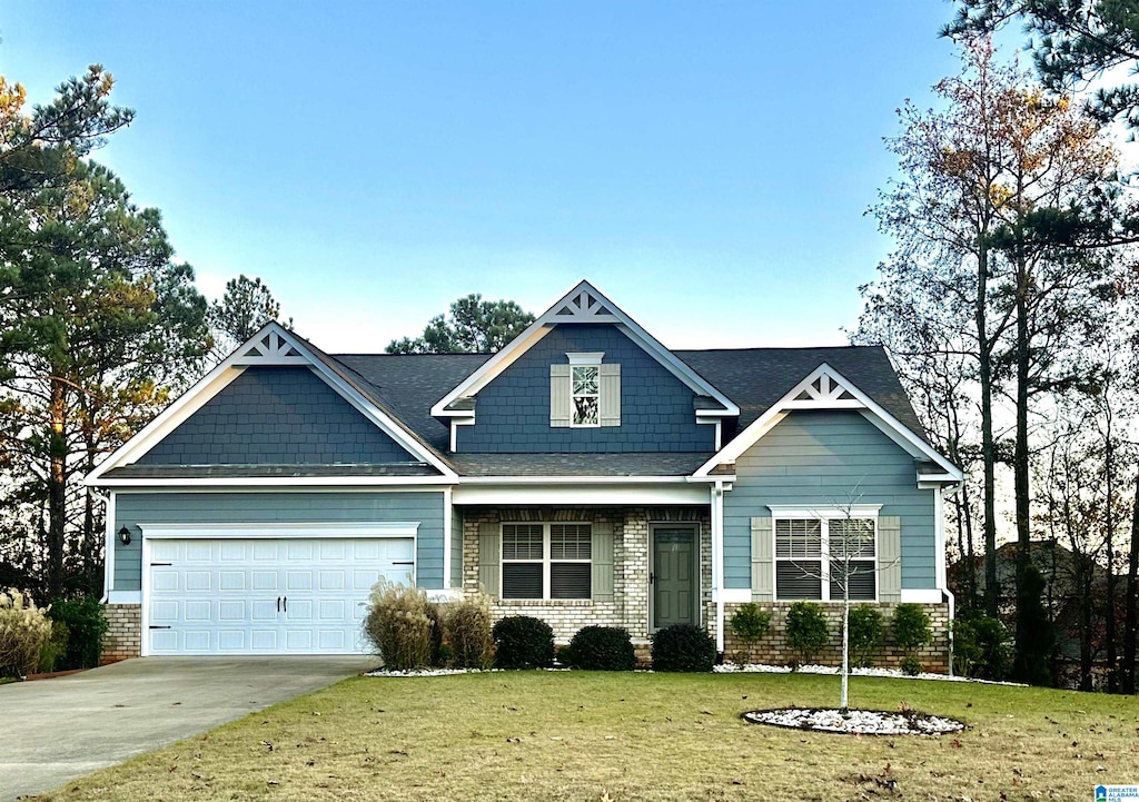 craftsman inspired home featuring a garage and a front lawn