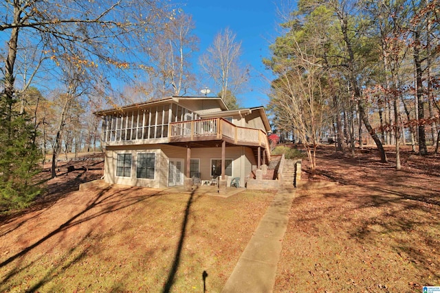 rear view of house featuring a patio and a sunroom