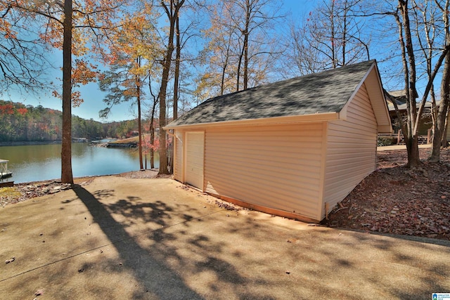 view of outdoor structure featuring a water view and a garage