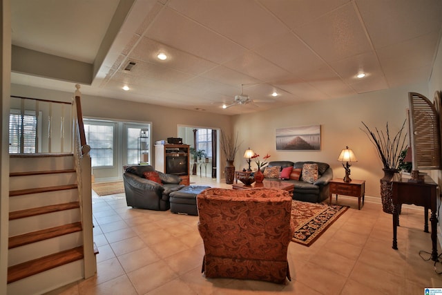 living room with ceiling fan and light tile patterned flooring