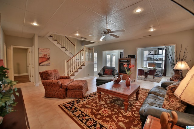 tiled living room with ceiling fan