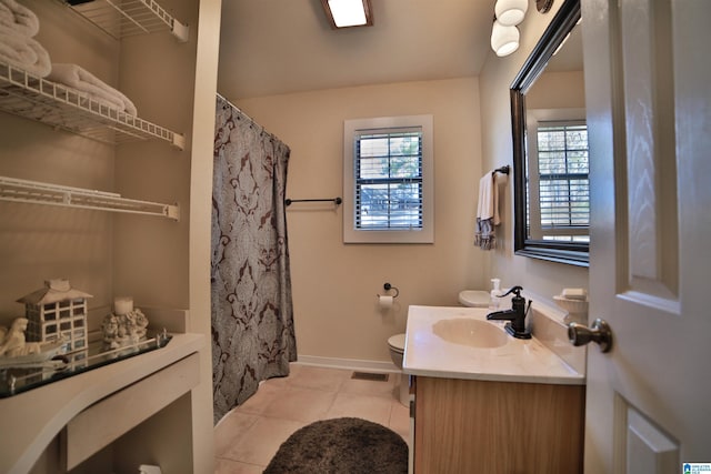 bathroom with tile patterned flooring, vanity, and toilet