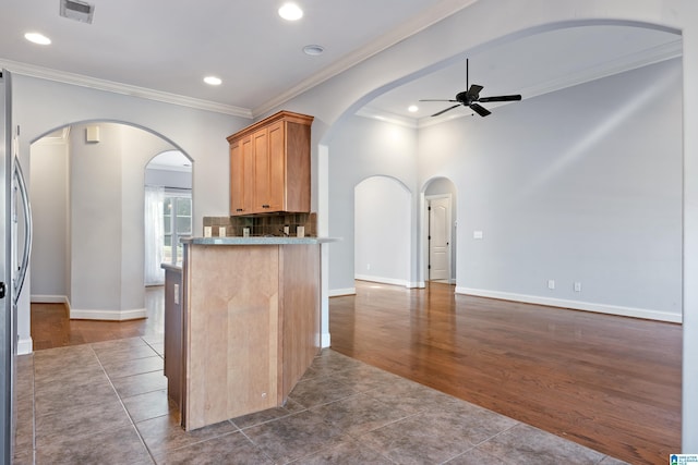 kitchen with dark hardwood / wood-style floors, ceiling fan, and crown molding