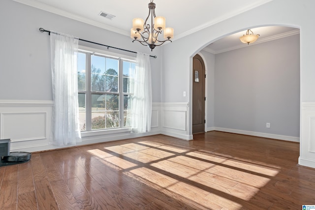 unfurnished dining area with crown molding, wood-type flooring, and a notable chandelier