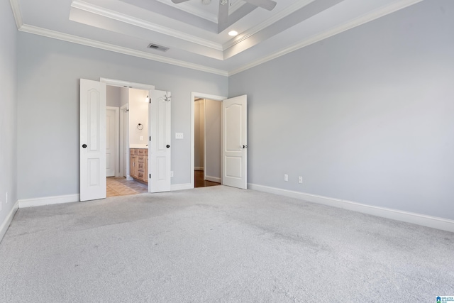 unfurnished bedroom with light colored carpet, a raised ceiling, ceiling fan, and ornamental molding