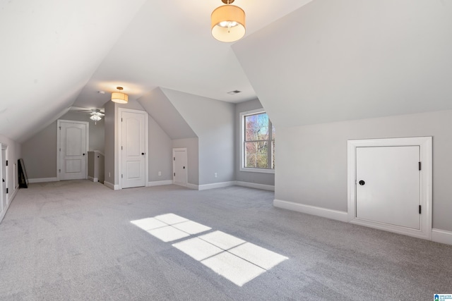 bonus room with light carpet, vaulted ceiling, and ceiling fan