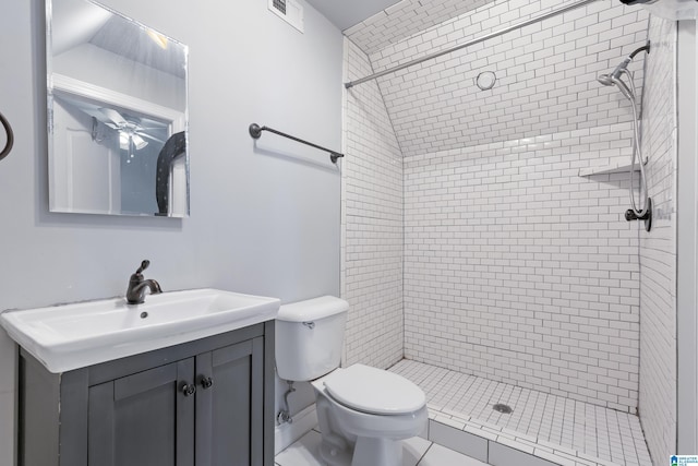 bathroom with tile patterned floors, vanity, toilet, and tiled shower