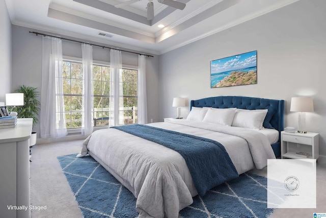 bedroom featuring carpet flooring, a tray ceiling, ceiling fan, and crown molding