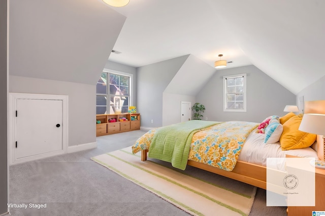 bedroom with light colored carpet and lofted ceiling