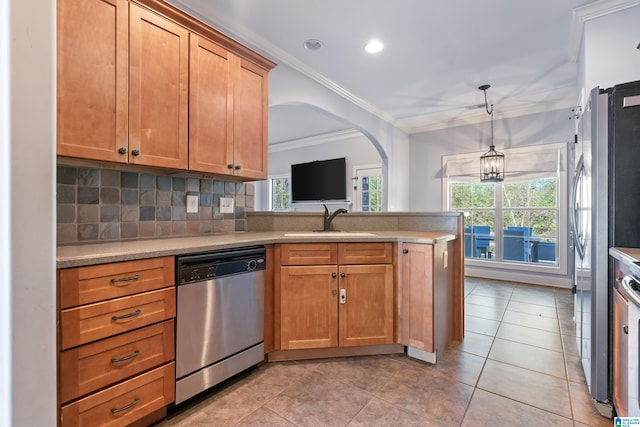 kitchen with appliances with stainless steel finishes, ornamental molding, sink, pendant lighting, and light tile patterned floors