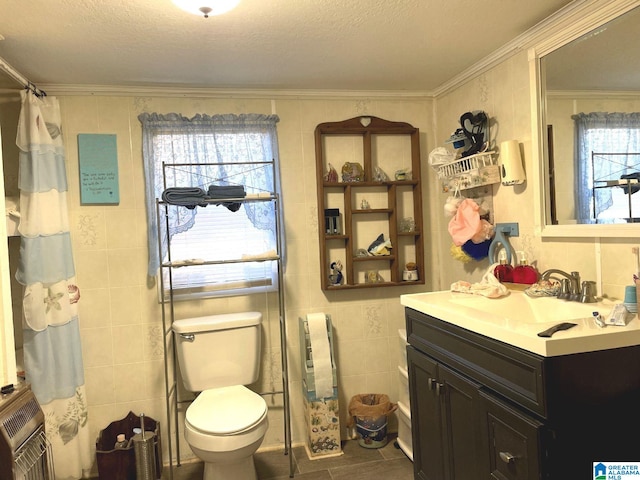 bathroom with a textured ceiling, plenty of natural light, tile walls, and ornamental molding