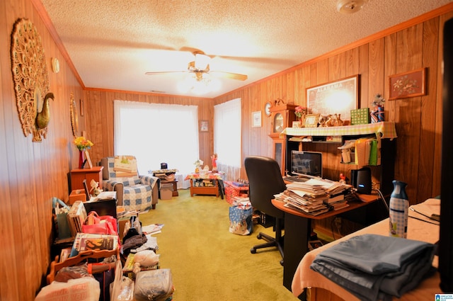 carpeted office space with ceiling fan, wood walls, and a textured ceiling