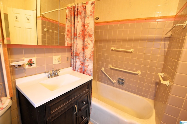 bathroom with decorative backsplash, shower / bath combo, vanity, and tile walls