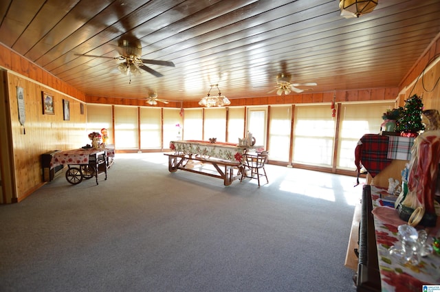 playroom featuring carpet, wooden ceiling, and wooden walls