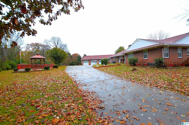 exterior space with a gazebo, an outdoor structure, and a garage