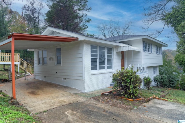 view of side of property with a carport