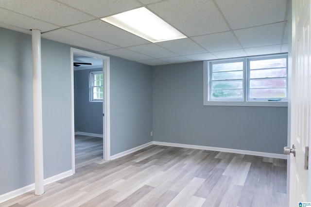 spare room featuring a drop ceiling and light wood-type flooring