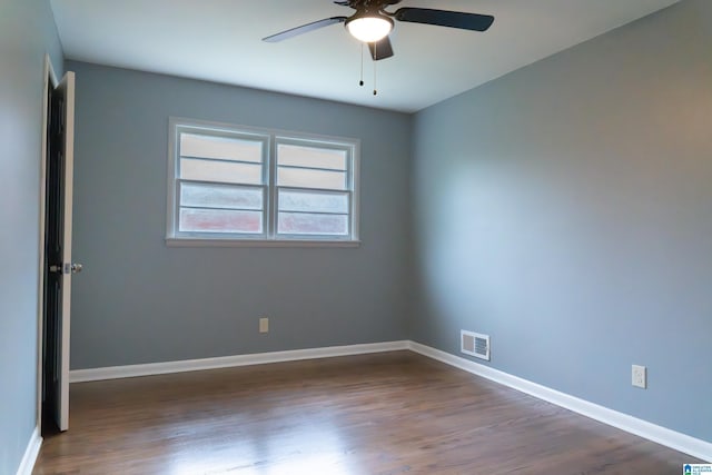 spare room with ceiling fan and dark hardwood / wood-style flooring