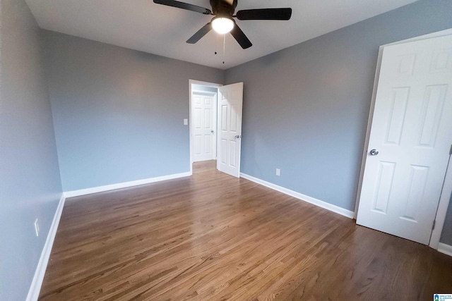 spare room with hardwood / wood-style flooring and ceiling fan