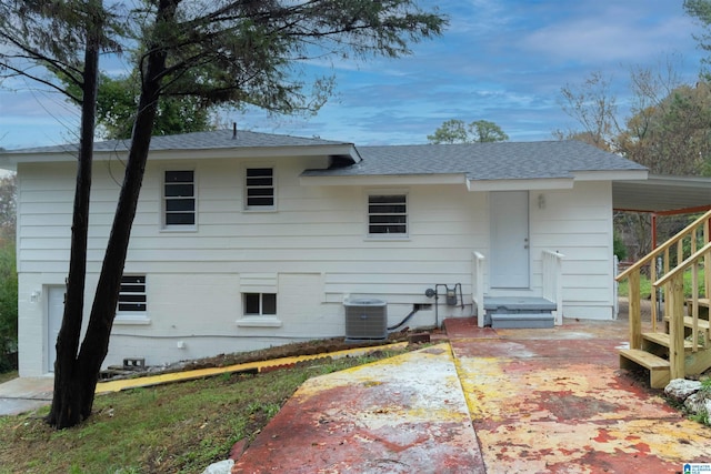 rear view of house with central air condition unit