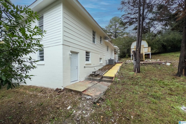 view of side of property with central air condition unit