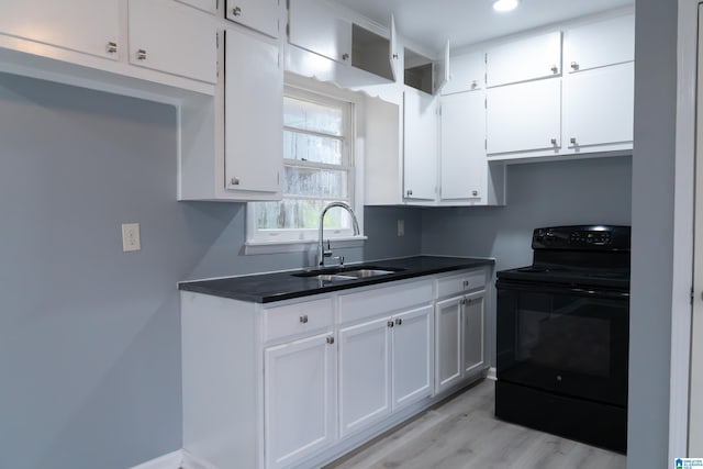 kitchen featuring light hardwood / wood-style floors, white cabinetry, black range with electric stovetop, and sink