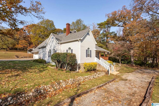 view of property exterior featuring a yard and a garage