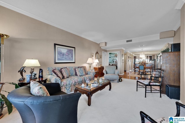 carpeted living room with a chandelier and ornamental molding