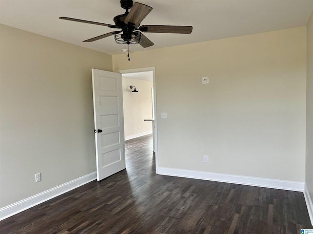 empty room featuring ceiling fan and dark hardwood / wood-style floors