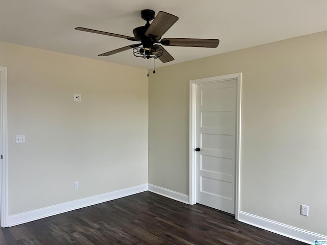 empty room featuring ceiling fan and dark wood-type flooring