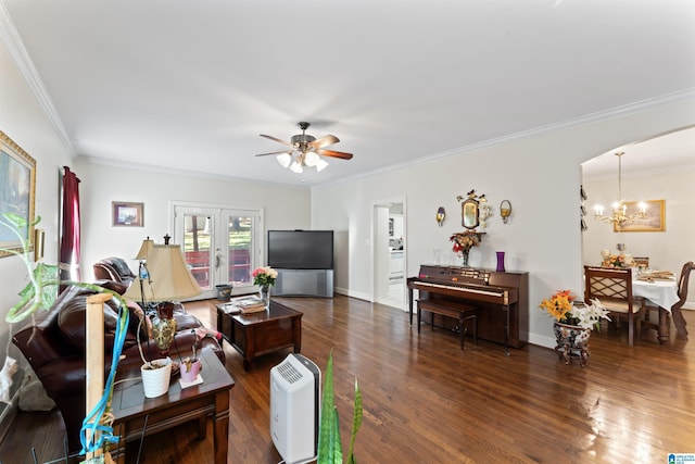 living room featuring dark hardwood / wood-style floors, ornamental molding, ceiling fan with notable chandelier, and french doors