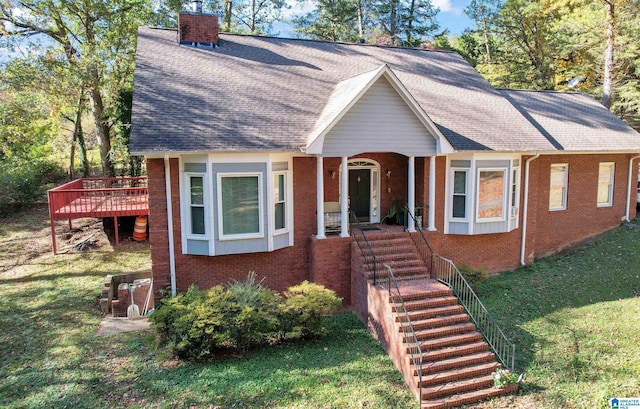 view of front of house featuring a deck and a front lawn